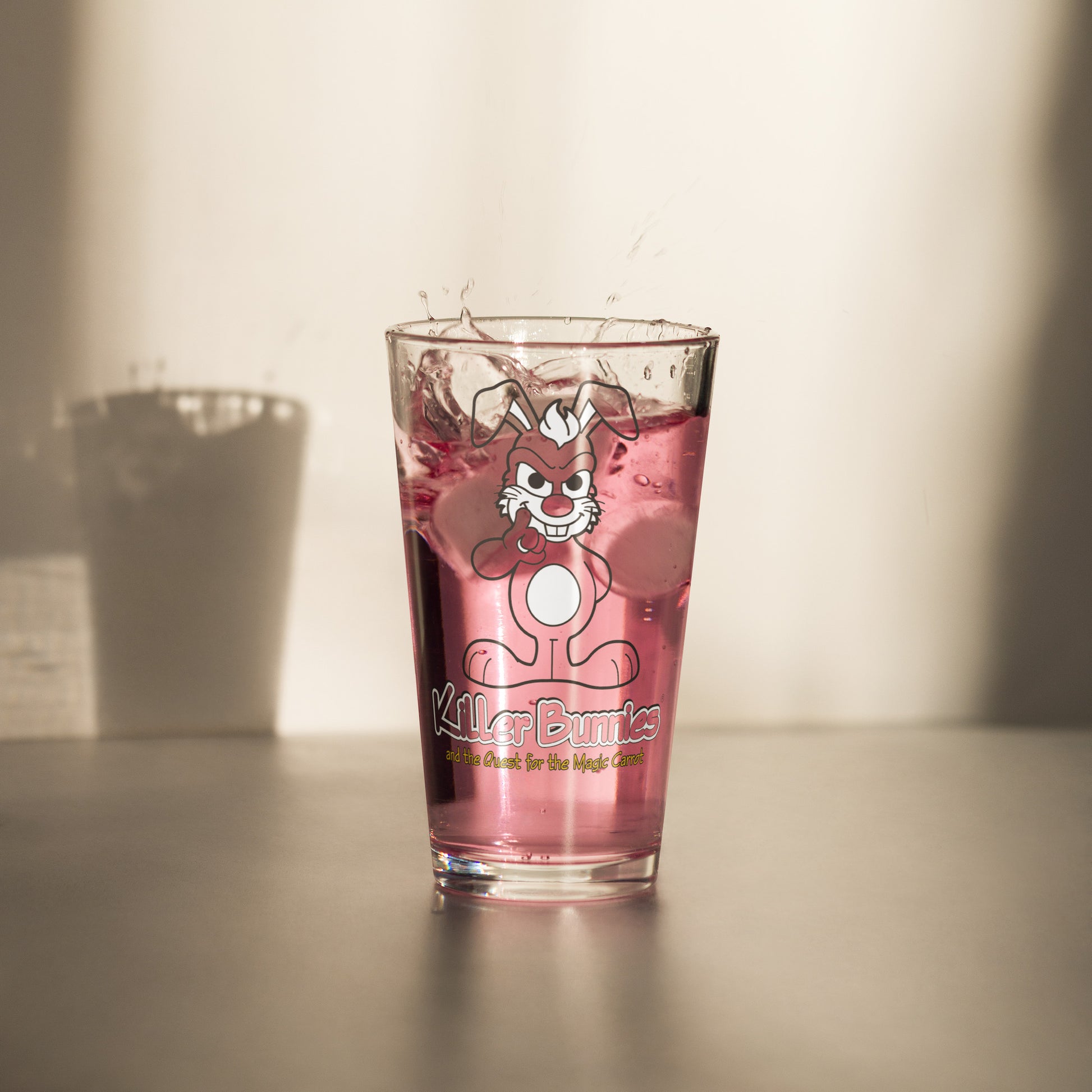 Person holding Evil Bunny Pint Glass with pink drink